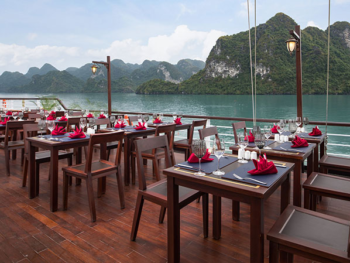 Outdoor dining area with stunning views on the Orchid Trendy Cruise, Ha Long Bay, Vietnam - Perfect for enjoying meals with breathtaking scenery