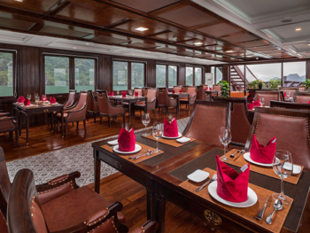 Elegant dining area with setup for fine dining on the Orchid Trendy Cruise, Ha Long Bay, Vietnam - Featuring beautiful table settings and panoramic windows
