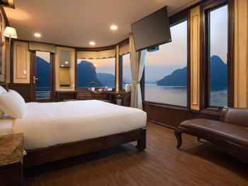 Luxurious cabin with panoramic views on the Orchid Trendy Cruise, Ha Long Bay, Vietnam - Featuring a comfortable bed and elegant decor