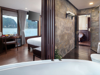 Luxurious suite with a view on the Orchid Trendy Cruise, Ha Long Bay, Vietnam - Featuring a spacious bathroom and comfortable bedroom.