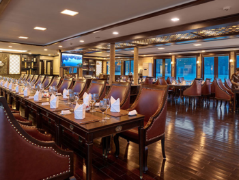 Elegant dining area on the Orchid Trendy Cruise, Ha Long Bay, Vietnam - Perfect for enjoying gourmet meals with stunning views.