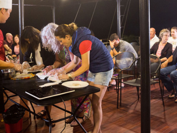 Guests participating in a cooking class on the deck of the Orchid Trendy Cruise, Ha Long Bay, Vietnam - Learning to make traditional Vietnamese dishes