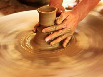 Participants creating ceramics and lacquer paintings at Bat Trang village, showcasing Vietnamese traditional crafts.